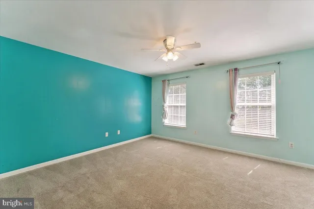 a view of an empty room with a fan
