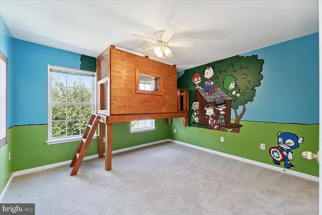 a view of a room with a window and a ceiling fan