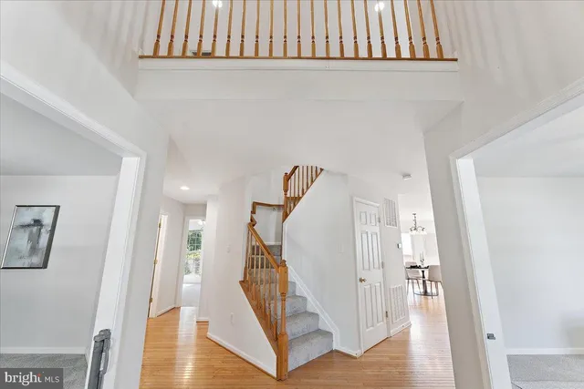 a view of a livingroom with wooden floor and stairs