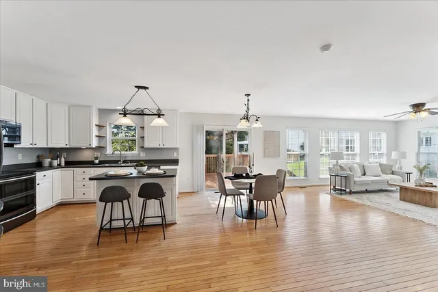 a view of a dining room with furniture window and wooden floor