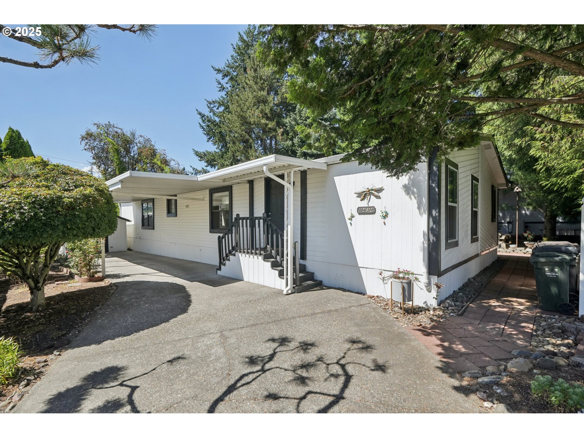 8434 Heritage Court, Unit 19 Clackamas, OR 97015 - Photo 1 of 28 a view of a white house with a yard and large tree