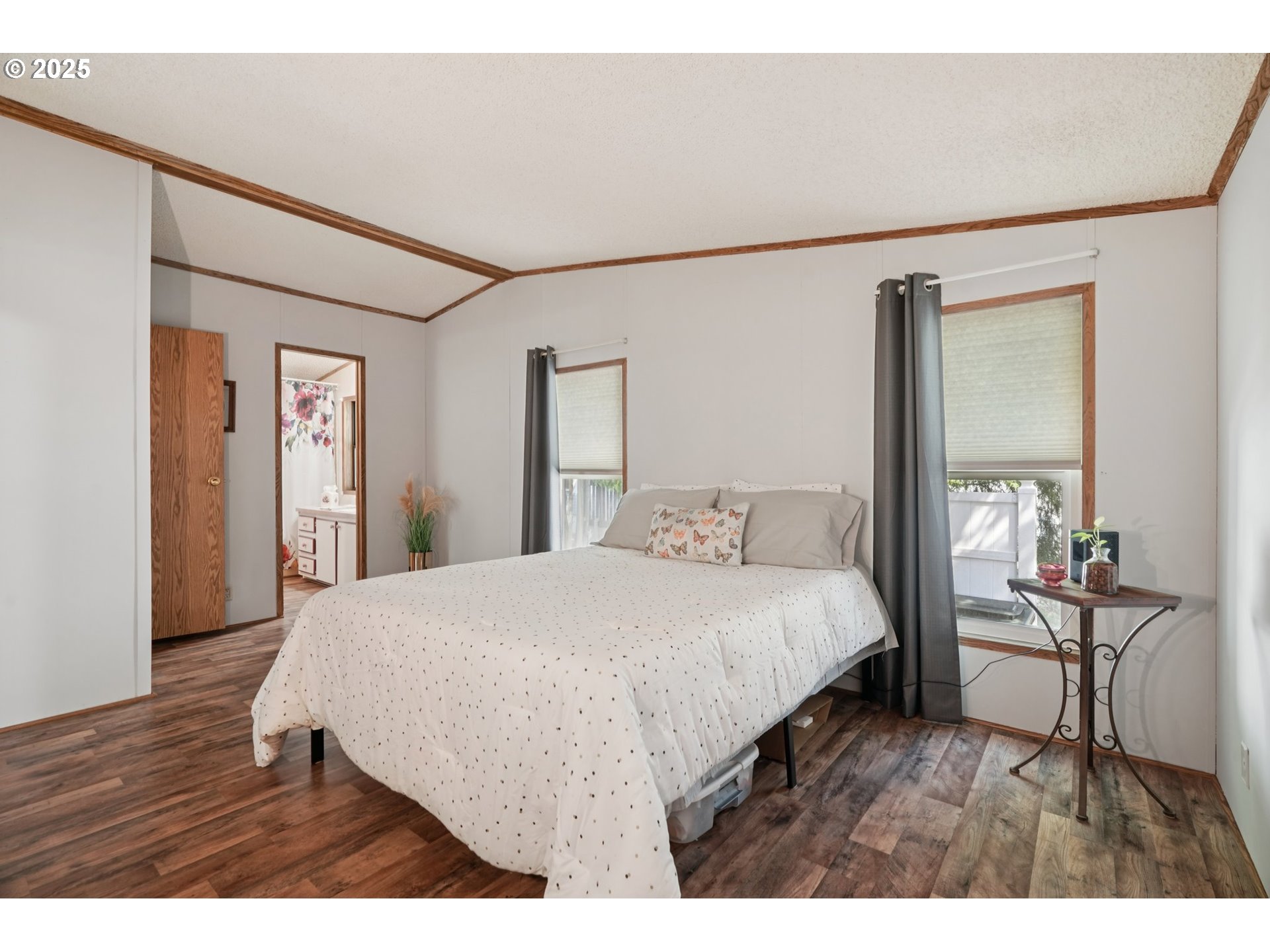 8434 Heritage Court, Unit 19 Clackamas, OR 97015 - Photo 13 of 28 a bedroom with a bed a table and painting