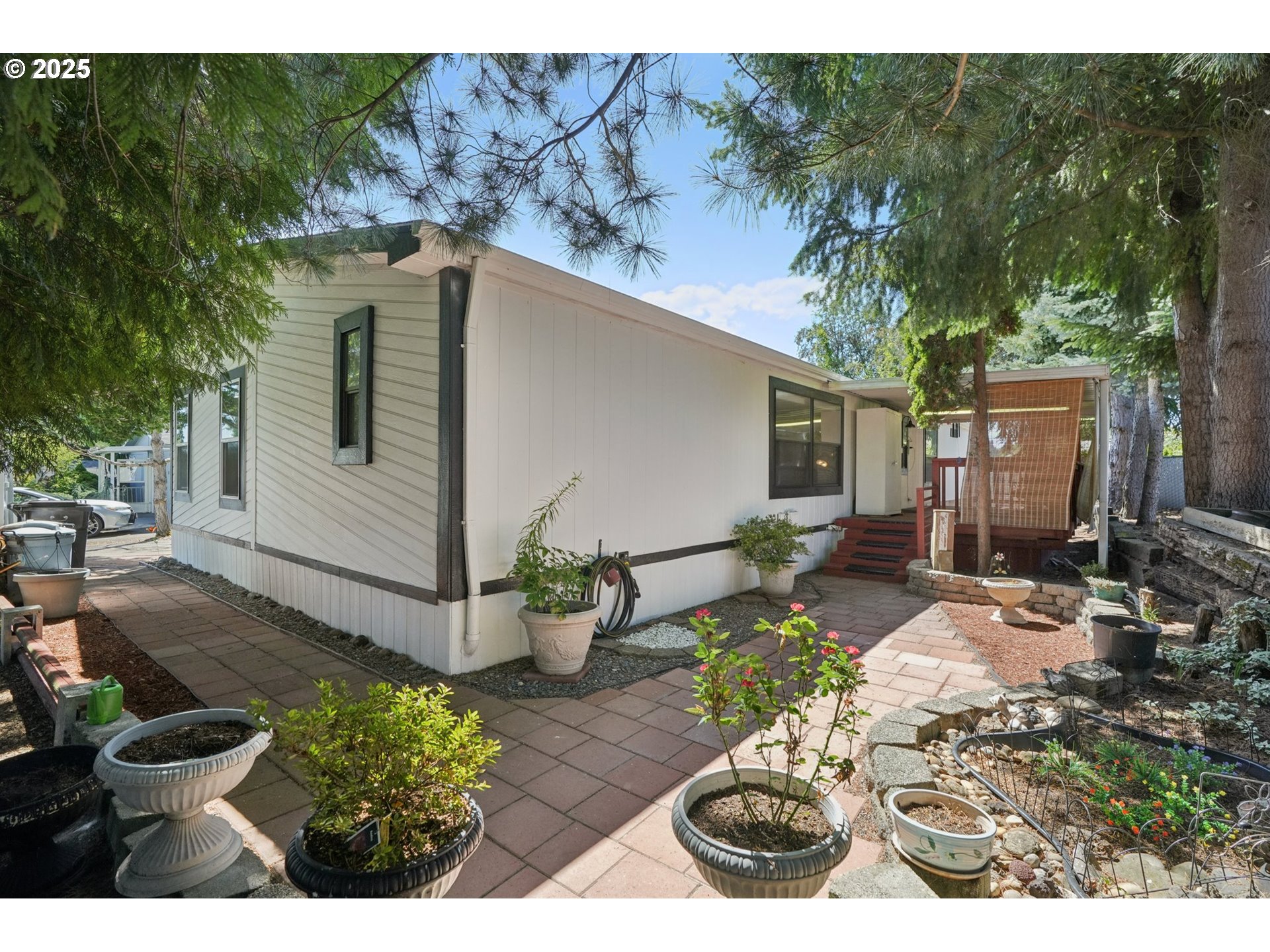 8434 Heritage Court, Unit 19 Clackamas, OR 97015 - Photo 23 of 28 a view of a backyard with chair and potted plants
