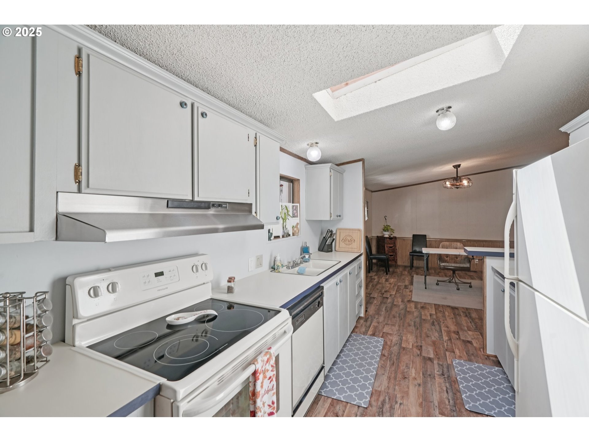 8434 Heritage Court, Unit 19 Clackamas, OR 97015 - Photo 9 of 28 a kitchen that has a lot of cabinets in it and wooden floors