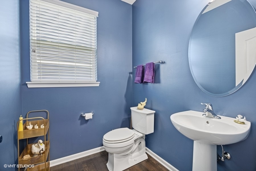 1683 Rockefeller Drive Mundelein, IL 60060 - Photo 12 of 25 a bathroom with a toilet sink and mirror