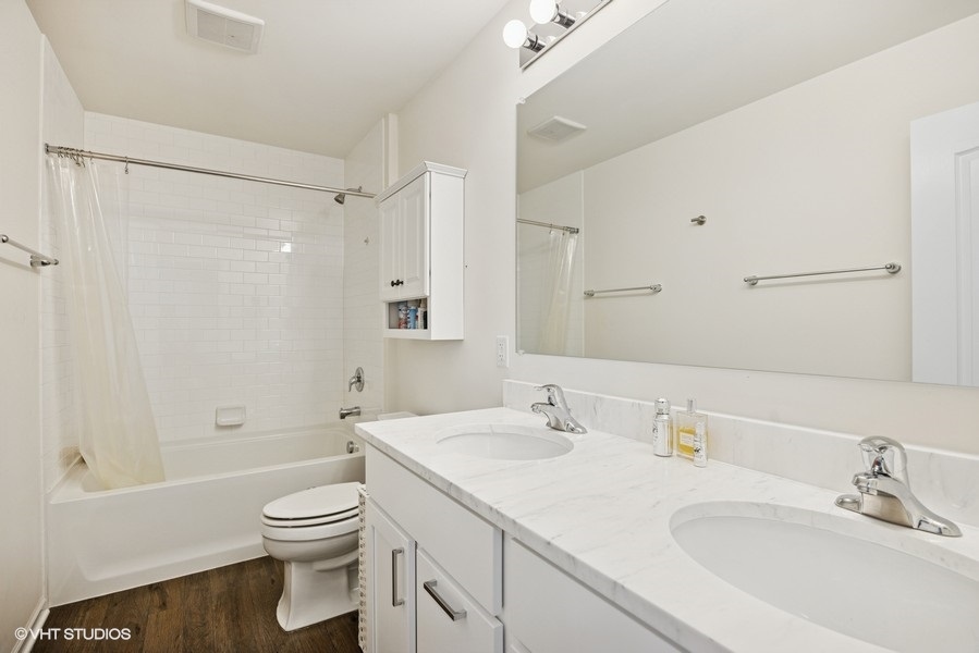 1683 Rockefeller Drive Mundelein, IL 60060 - Photo 18 of 25 a bathroom with a sink toilet a shower and a mirror