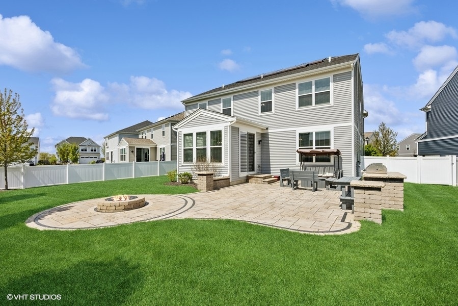 1683 Rockefeller Drive Mundelein, IL 60060 - Photo 20 of 25 a view of a house with a backyard and a patio