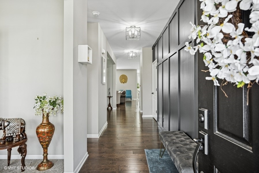 1683 Rockefeller Drive Mundelein, IL 60060 - Photo 3 of 25 an entryway with a flower pot and a chandelier