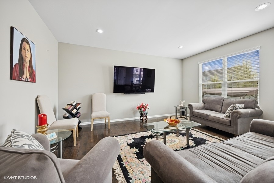 1683 Rockefeller Drive Mundelein, IL 60060 - Photo 6 of 25 a living room with furniture and a flat screen tv