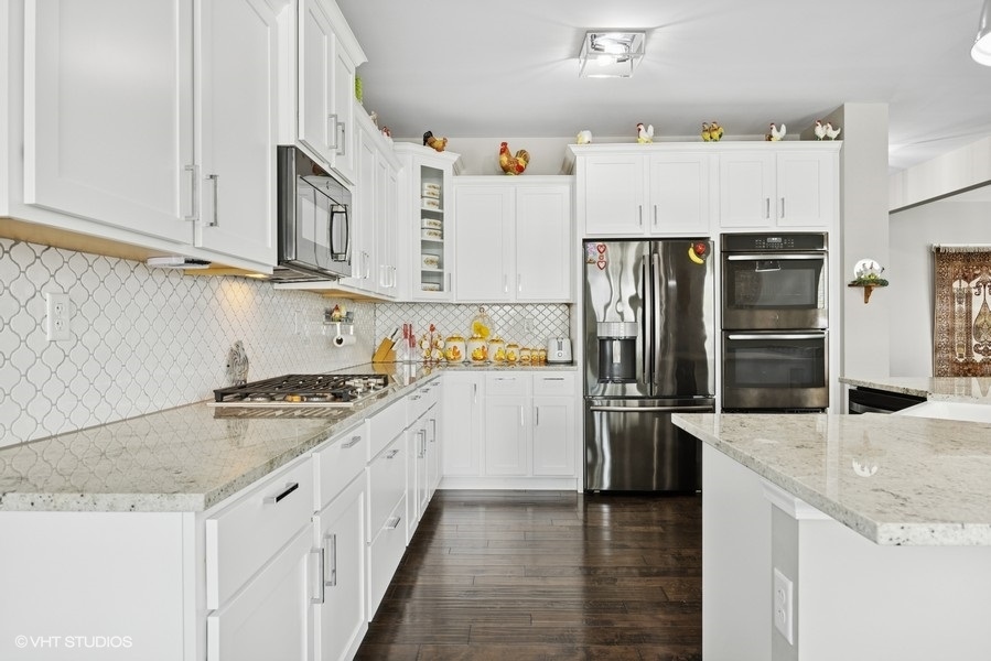 1683 Rockefeller Drive Mundelein, IL 60060 - Photo 8 of 25 a kitchen with stainless steel appliances granite countertop a refrigerator and a stove