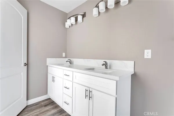 a spacious bathroom with a double vanity sink and a mirror
