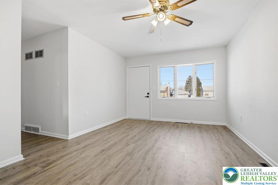 1333 Ridge Trail Easton, PA 18040 - Photo 4 of 34 an empty room with wooden floor chandelier fan and windows