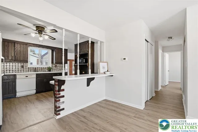 a kitchen with a refrigerator and white cabinets
