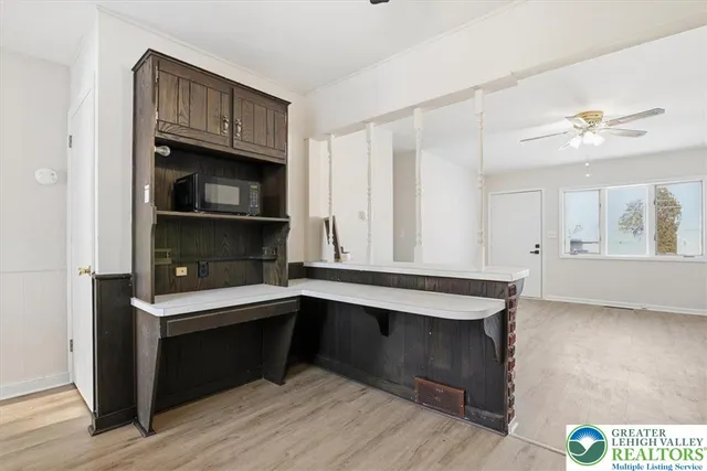 a kitchen with a sink cabinets and wooden floor