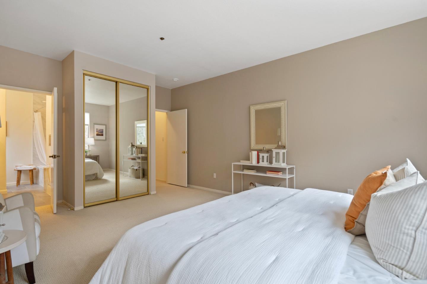 525 Almer Road, Unit 210 Burlingame, CA 94010 - Photo 17 of 36 a bedroom with a large bed and a chandelier