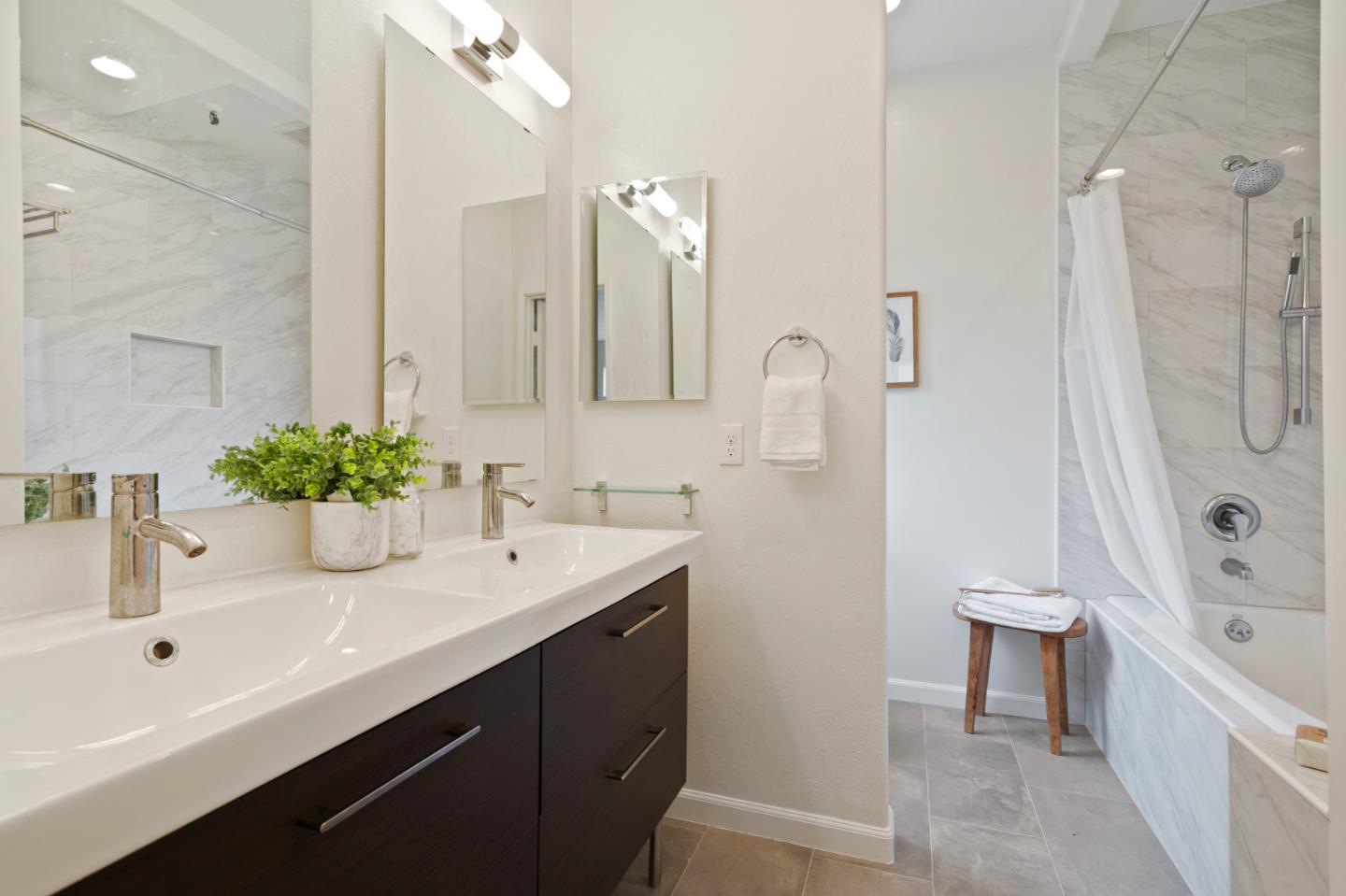 525 Almer Road, Unit 210 Burlingame, CA 94010 - Photo 18 of 36 a bathroom with a tub sink and mirror