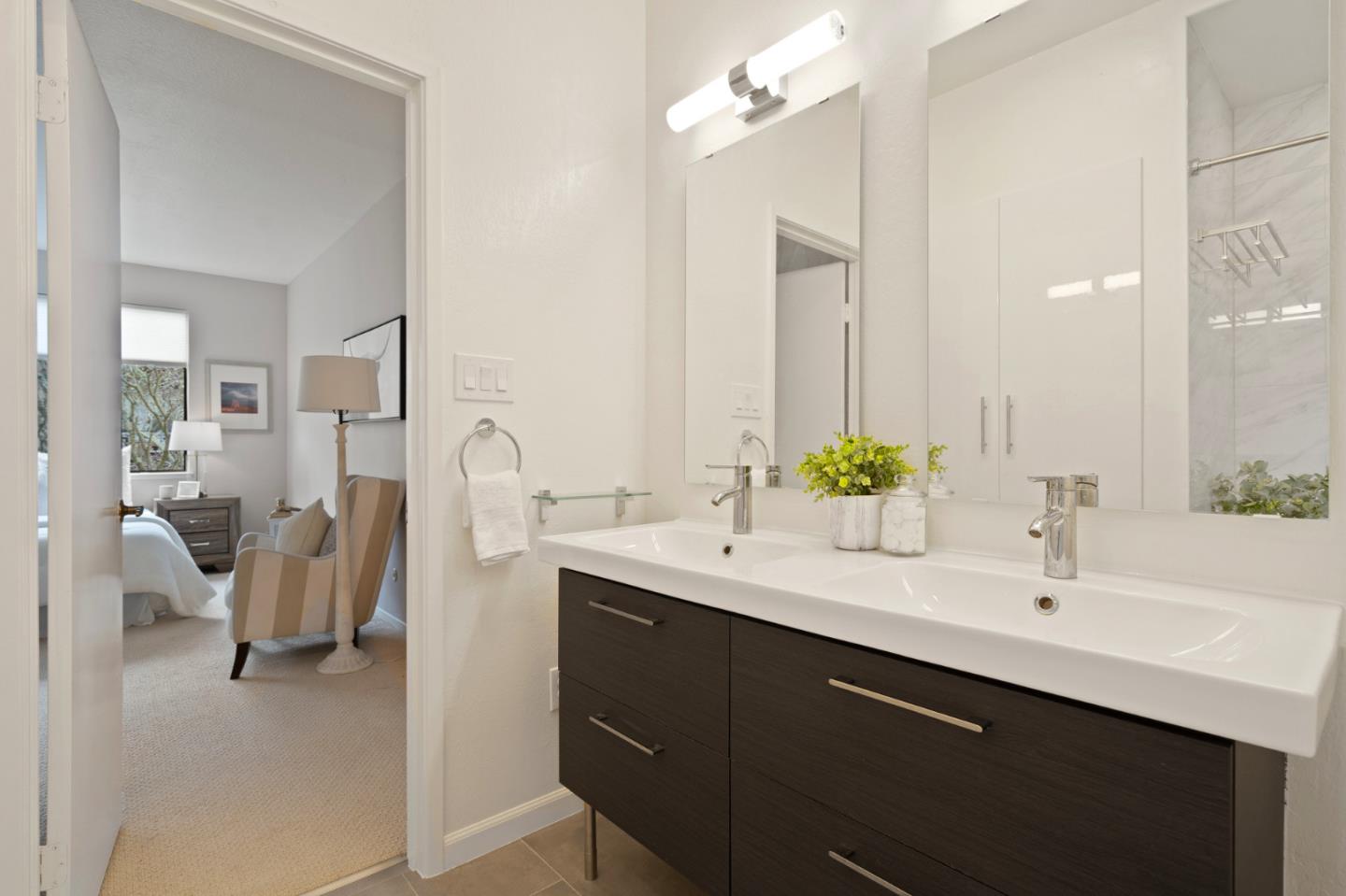 525 Almer Road, Unit 210 Burlingame, CA 94010 - Photo 20 of 36 a en suite bathroom with a double vanity sink and a mirror