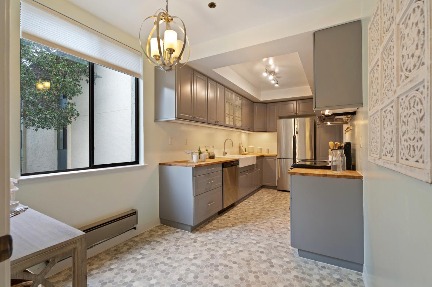 525 Almer Road, Unit 210 Burlingame, CA 94010 - Photo 3 of 36 a kitchen with stainless steel appliances granite countertop a refrigerator a sink dishwasher a stove and white cabinets with wooden floor