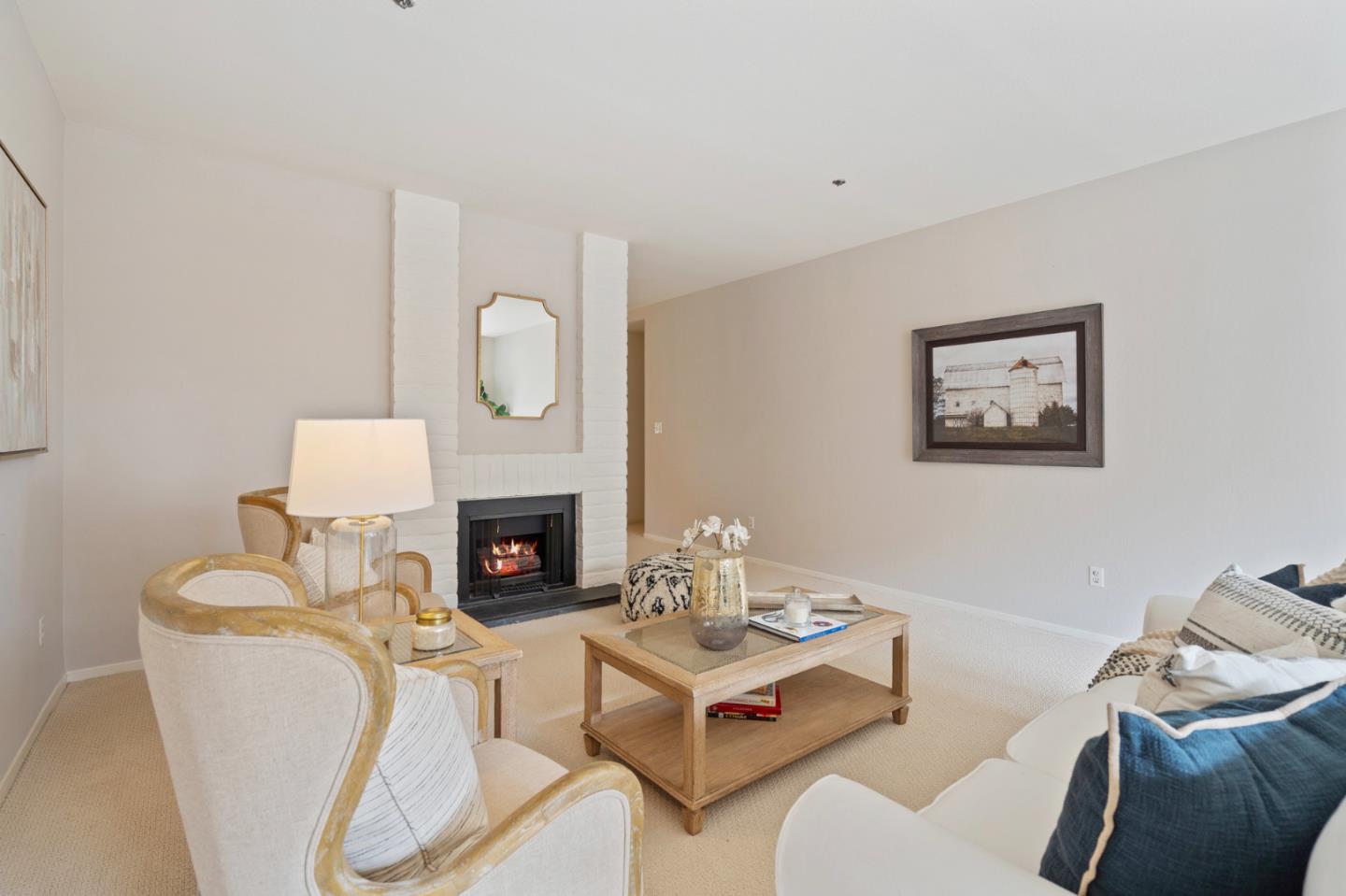 525 Almer Road, Unit 210 Burlingame, CA 94010 - Photo 9 of 36 a living room with furniture a fireplace and a large mirror