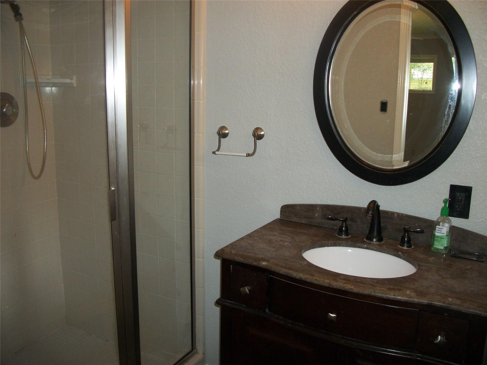 111 Shadylyn Drive Conroe, TX 77304 - Photo 11 of 18 a bathroom with a sink and a mirror