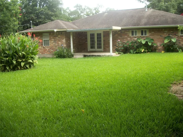 a view of a house with yard and a garden