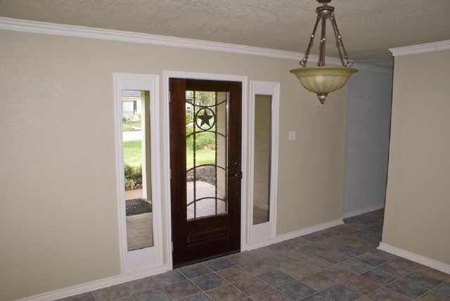 111 Shadylyn Drive Conroe, TX 77304 - Photo 4 of 18 a view of a hallway with windows and chandelier