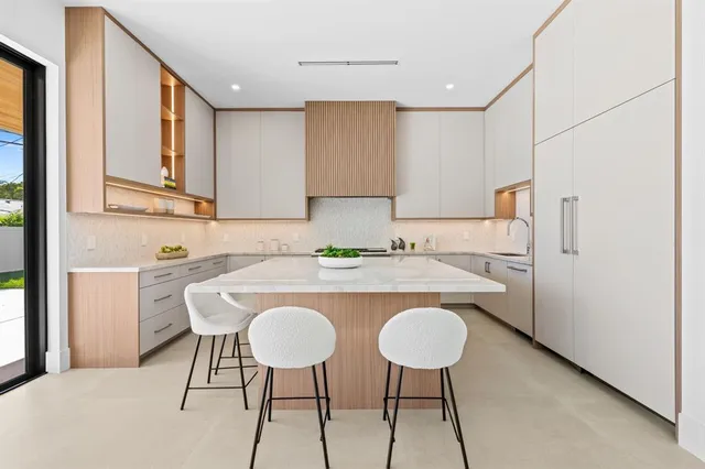 a view of kitchen with cabinets counter space and chairs