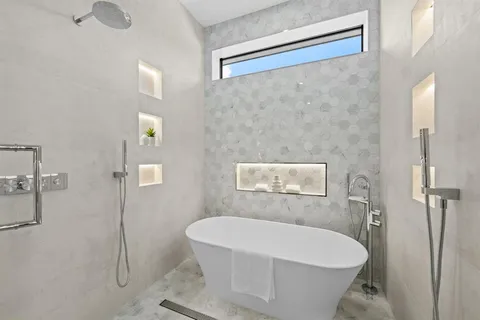 a white bath tub sitting in a bathroom