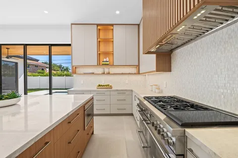 a kitchen that has a sink and a stove