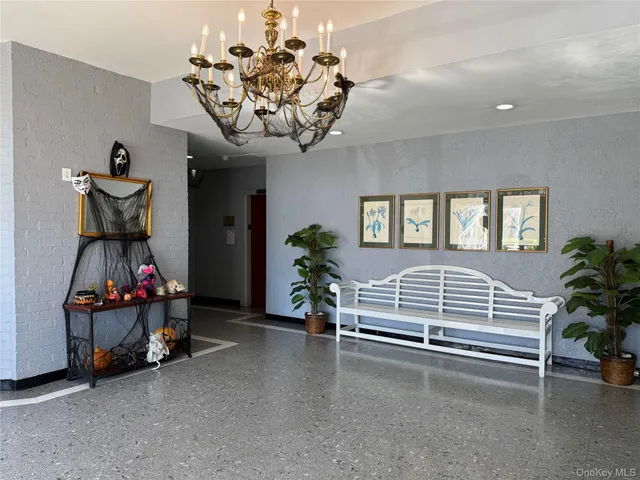 a bedroom with furniture and a chandelier
