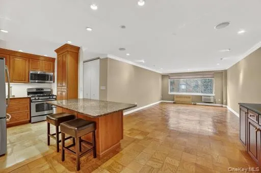 a kitchen with stainless steel appliances granite countertop a stove and a refrigerator
