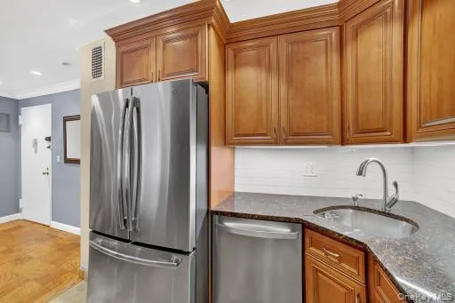 a kitchen with stainless steel appliances granite countertop a refrigerator and a sink