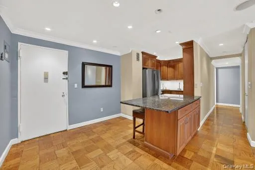 a kitchen with stainless steel appliances granite countertop a sink and a refrigerator