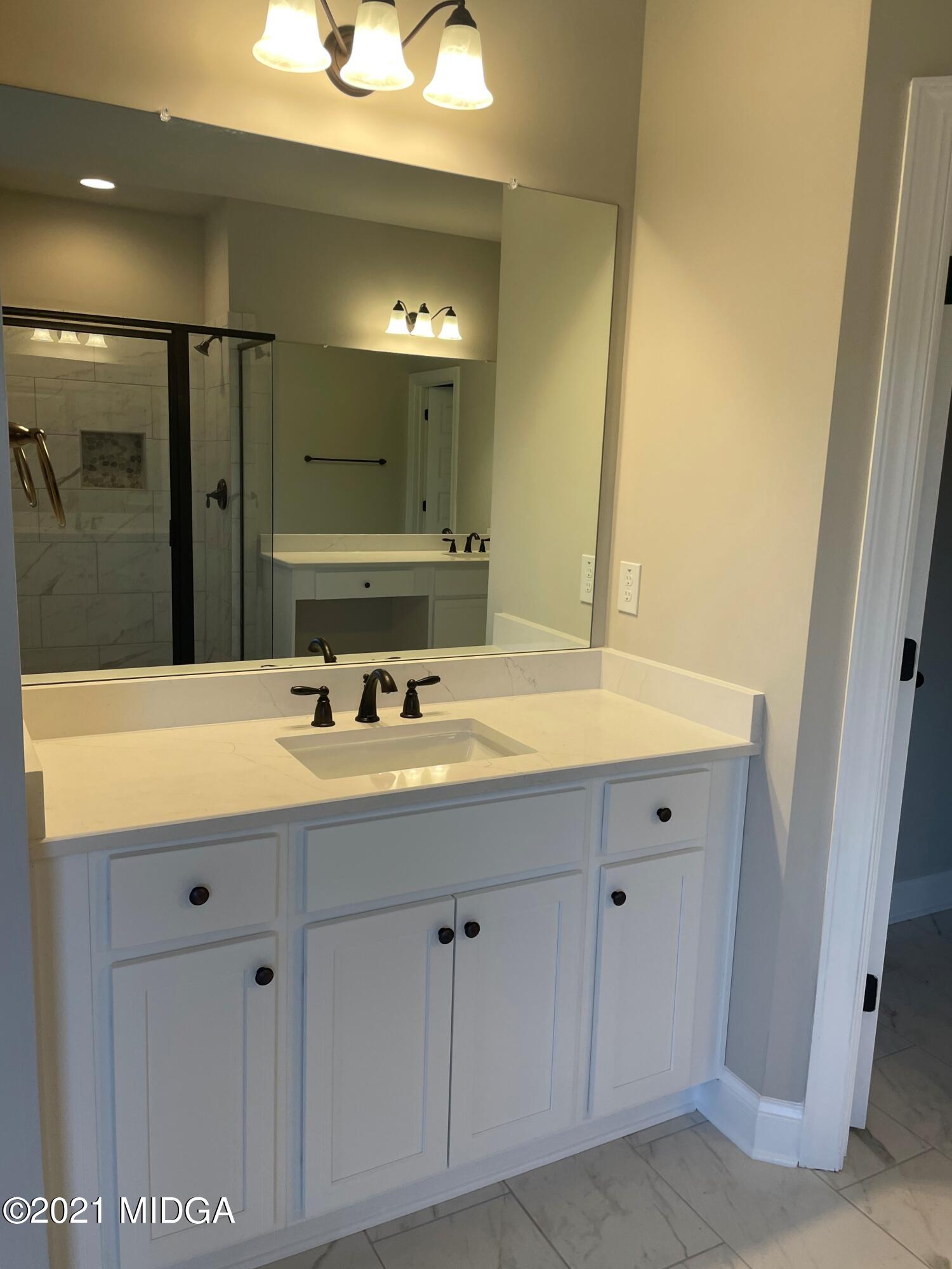 1154 Bunn Road Forsyth, GA 31029 - Photo 8 of 9 a bathroom with a double vanity sink and mirror