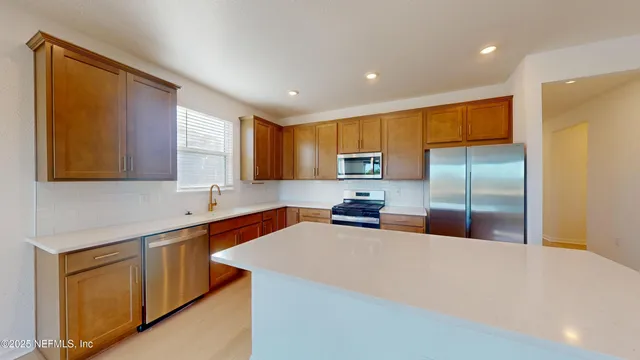 a stove top oven sitting inside of a kitchen