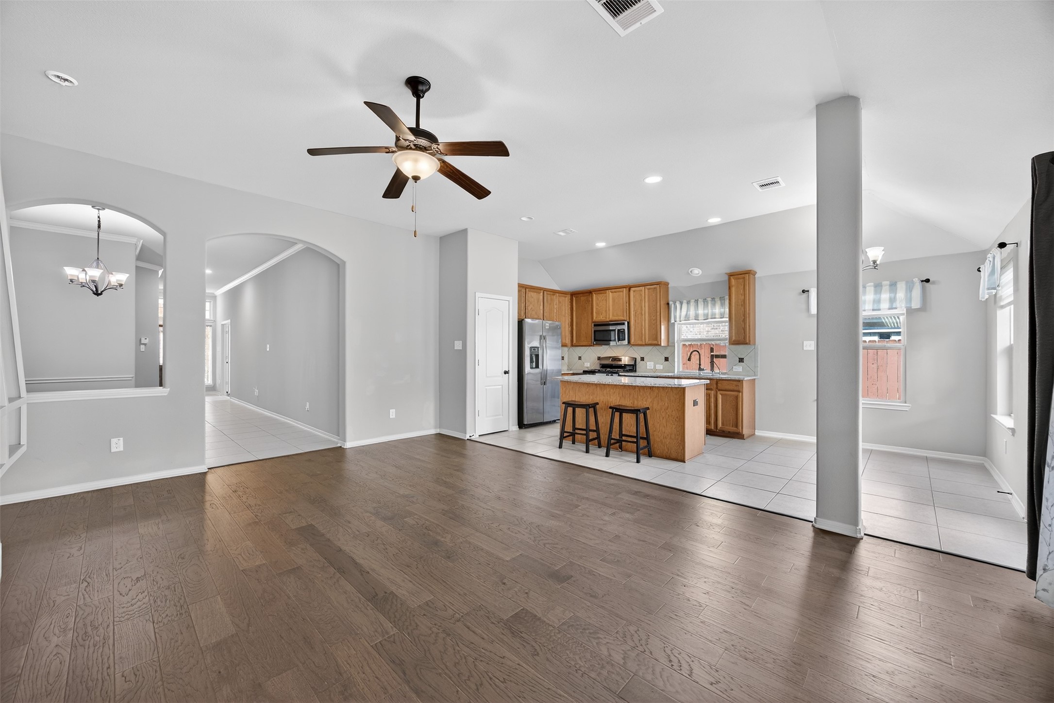 2009 Scissor Tail Road Pearland, TX 77581 - Photo 11 of 41 a view of a kitchen with refrigerator and wooden floor
