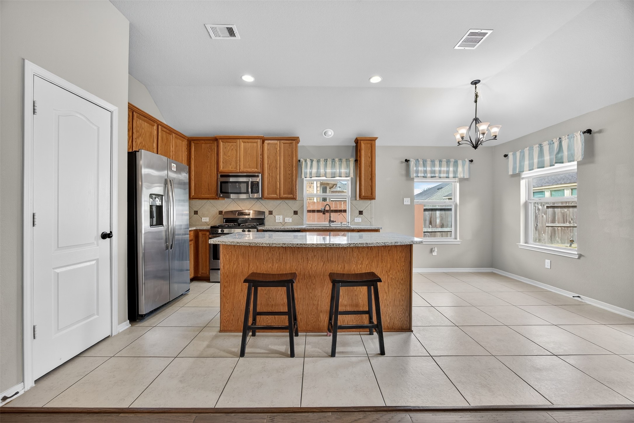 2009 Scissor Tail Road Pearland, TX 77581 - Photo 14 of 41 a kitchen with stainless steel appliances granite countertop a refrigerator a sink a stove and a cabinets