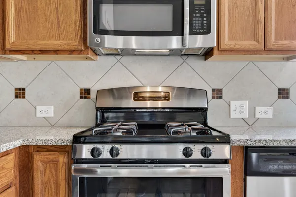 a stove top oven sitting inside of a kitchen