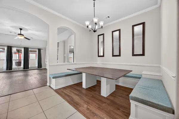 a spacious bathroom with a granite countertop sink a toilet a mirror and vanity