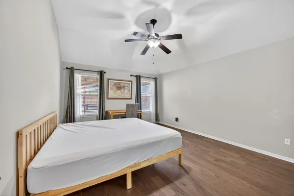 a bedroom with a large bed and a window