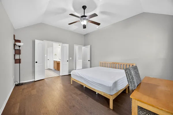 a bedroom with a bed and a ceiling fan