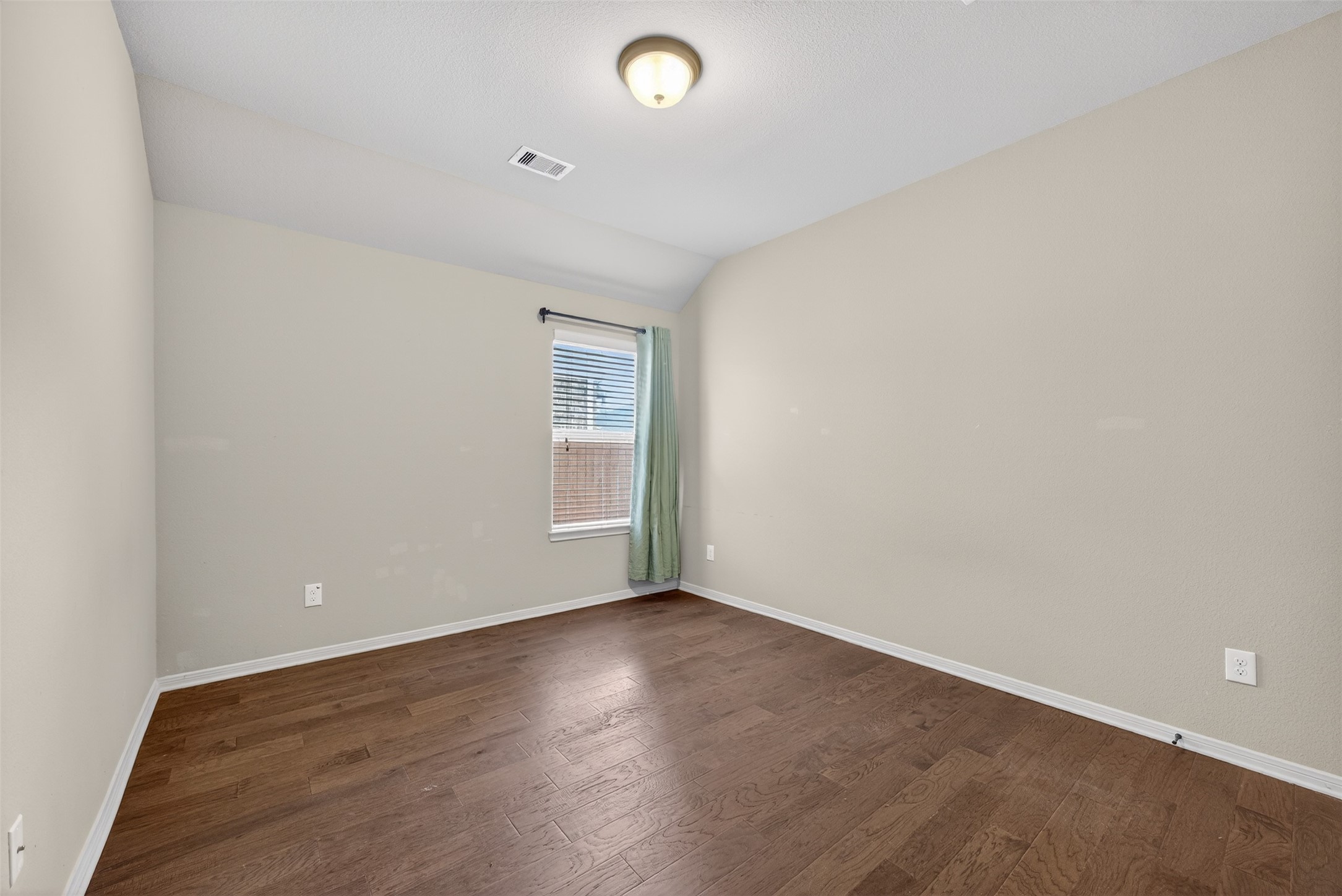 2009 Scissor Tail Road Pearland, TX 77581 - Photo 29 of 41 an empty room with wooden floor and windows