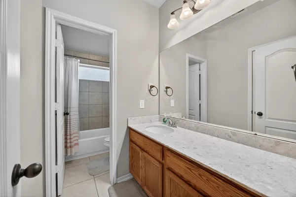 a bathroom with a sink a vanity and a large mirror