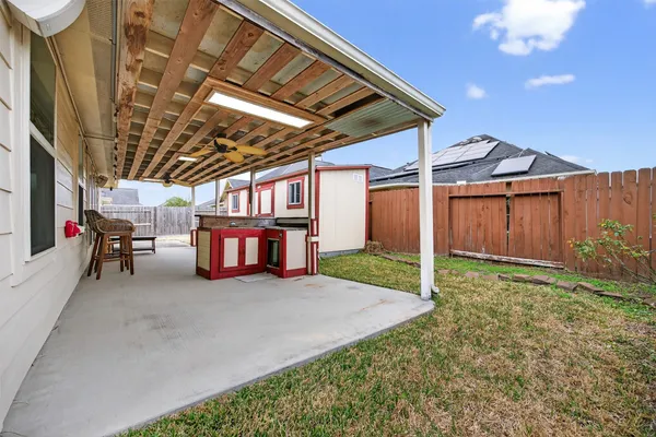 a view of a house with backyard and porch