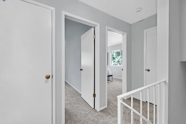 a view of a hallway with closet and door