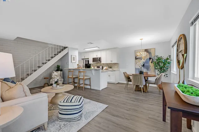 a living room with furniture and a dining room
