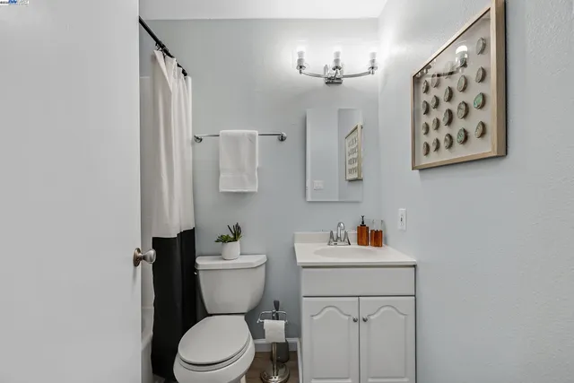 a white toilet sitting next to a bathroom sink