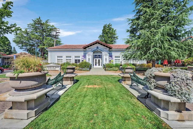 a view of a house with backyard sitting area and garden