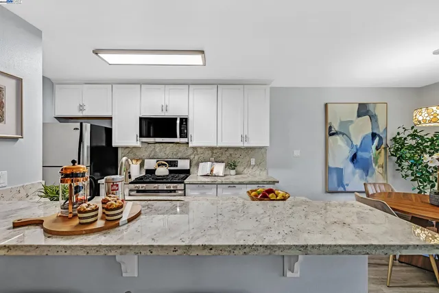 a kitchen with a sink a stove and a wooden cabinets