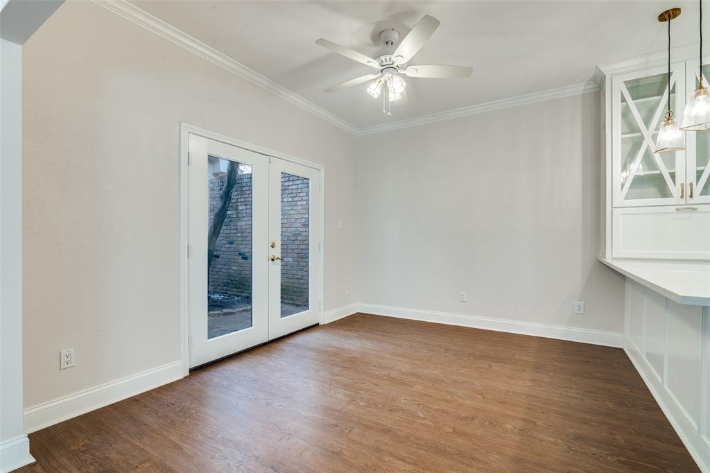 6027 High Court Place Dallas, TX 75254 - Photo 13 of 26 an empty room with wooden floor chandelier fan and windows